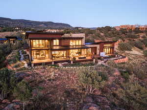 Back of property with a deck with mountain view