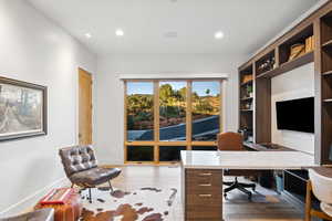 Office area with light hardwood / wood-style flooring