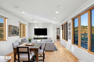 Dining room featuring light hardwood / wood-style flooring and a healthy amount of sunlight