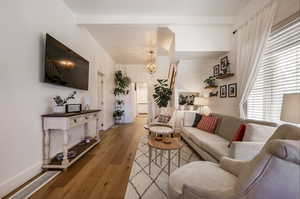 Living room featuring light hardwood / wood-style flooring and a notable chandelier