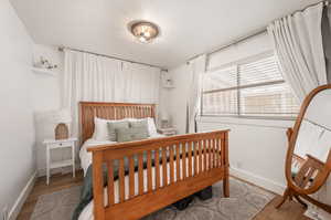 Bedroom with light hardwood / wood-style floors