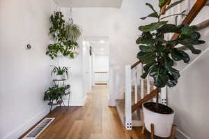 Hallway with light hardwood / wood-style flooring