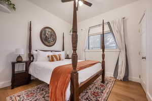 Bedroom with light hardwood / wood-style floors and ceiling fan