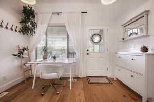 Entrance foyer with light hardwood / wood-style floors and plenty of natural light