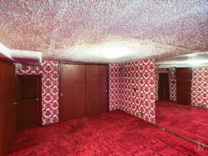 Unfurnished bedroom featuring a textured ceiling and carpet flooring