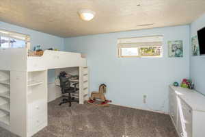 Interior space with a textured ceiling and multiple windows