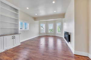 Large main floor office with build in cabinetry and large windows