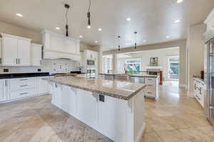 Freshly painted white cabinets, granite countertops, double islands