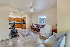 Apartment living room with light hardwood / wood-style flooring and ceiling fan