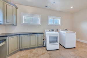 Upstairs deluxe laundry room with custom cabinetry