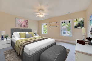 Bedroom featuring multiple windows, carpet flooring, and ceiling fan