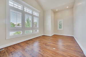 Front living room, office or music room with hardwood floors and large windows