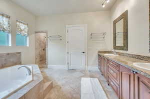 Double sinks, jetted tub and travertine tub