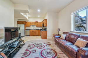 Basement apartment living room featuring light hardwood / wood-style flooring and sink