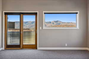 Interior space featuring carpet flooring and a mountain view