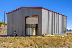 View of outbuilding featuring a garage