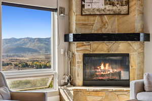 Room details featuring a mountain view and a fireplace