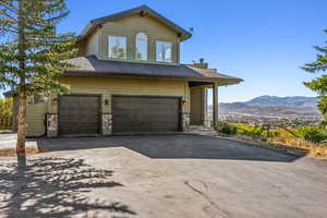 View of front of property featuring a mountain view and a garage