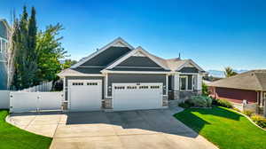 Craftsman-style home featuring a garage and a front lawn