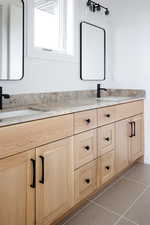 Bathroom with tile patterned floors and vanity