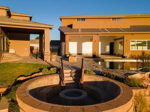 Back of house with a patio area and a fire pit