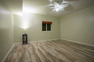 Unfurnished room featuring ceiling fan and light hardwood / wood-style flooring