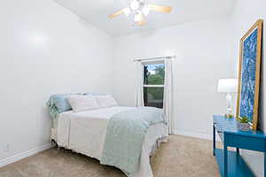 Bedroom with light carpet and ceiling fan