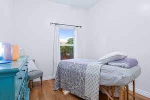 Bedroom with light hardwood / wood-style flooring