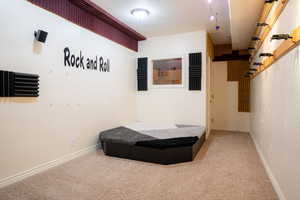 Bedroom with a textured ceiling and carpet