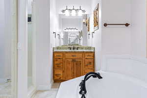 Bathroom with a tub to relax in and vanity