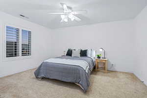 Carpeted bedroom featuring ceiling fan