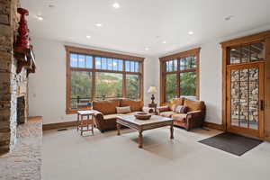 Carpeted living room featuring a fireplace