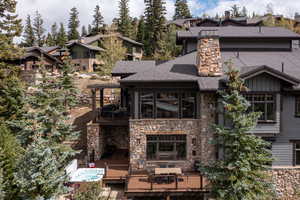 Rear view of house featuring a wooden deck