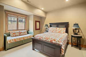 Bedroom featuring light colored carpet