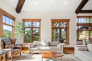 Living room featuring beam ceiling and hardwood / wood-style floors