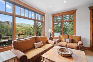 Living room featuring a wealth of natural light and carpet flooring