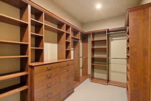 Walk in closet featuring light carpet