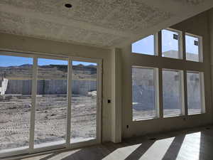 Doorway to outside featuring wood-type flooring, a mountain view, and a wealth of natural light