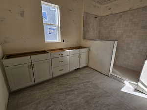 Bathroom with vanity and tiled shower