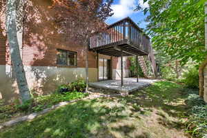 Rear view of house with a covered patio and deck