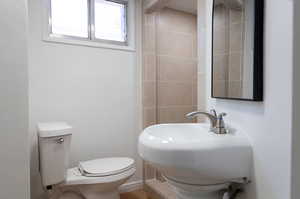 Bathroom with sink, hardwood / wood-style floors, and toilet