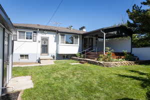 Rear view of property featuring a lawn