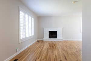 Unfurnished living room with light hardwood / wood-style floors