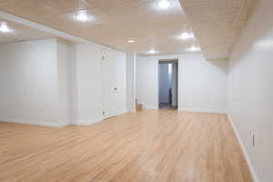 Interior space with light wood-type flooring and a paneled ceiling