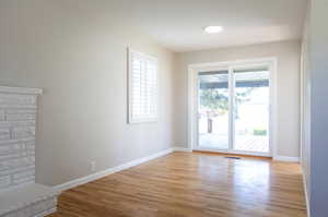 Spare room featuring light hardwood / wood-style flooring and a wealth of natural light