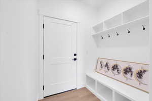 Mudroom featuring light wood-type flooring