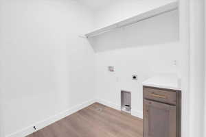 Laundry room featuring washer hookup, hookup for an electric dryer, and light wood-type flooring