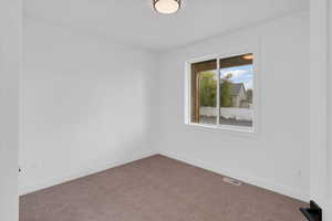 View of carpeted spare room