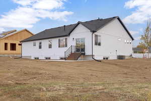 Rear view of property with central AC