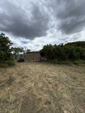 View of yard with a storage shed